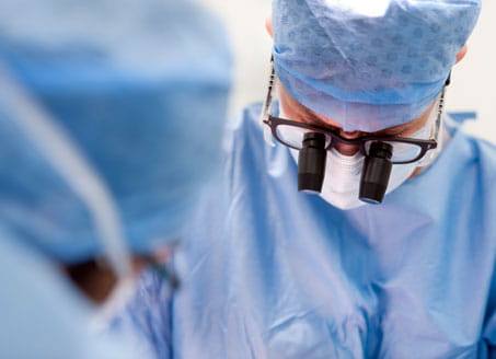 Image of surgeon with binoculars. Credit: Science Photo Library